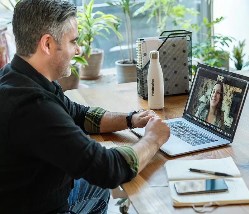 A client talking to a real estate broker in a café on a Zoom call